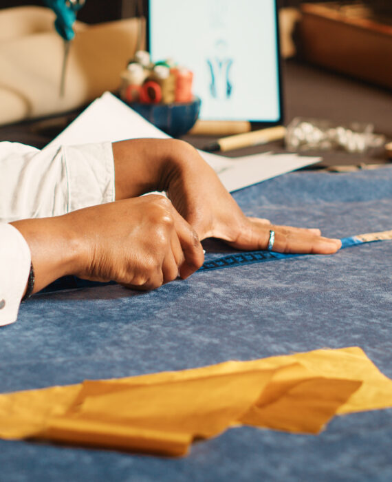 tailor-measuring-blue-fabric-custom-clothing-workshop-professional-dressmaking